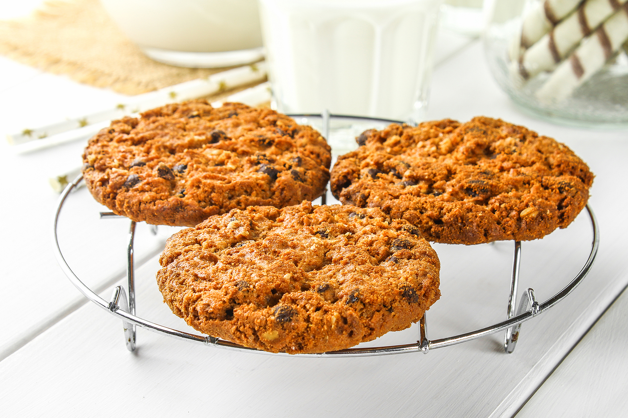 Homemade oatmeal cookies. Cookies on an iron grate on a wooden white table